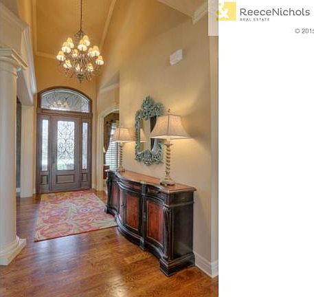 A grand entry with soaring ceilings and stylish lighting welcome