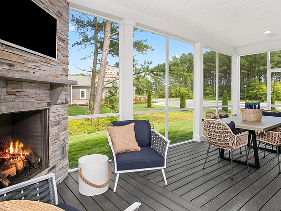 Screened porch with corner fireplace in a DRB Homes St. Kitts Model Home.