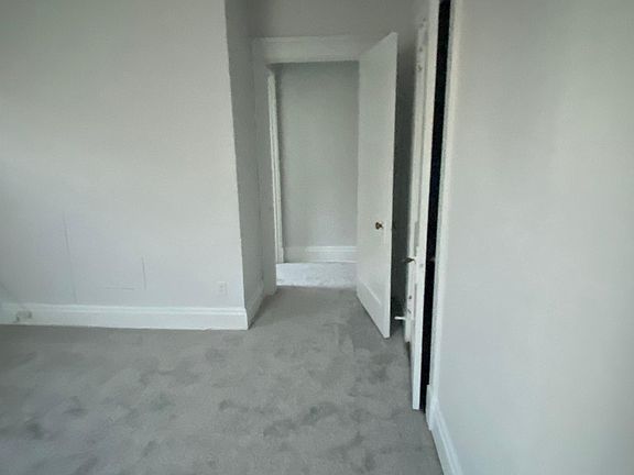Back bedroom looking out towards hallway. Bedroom next to bathroom