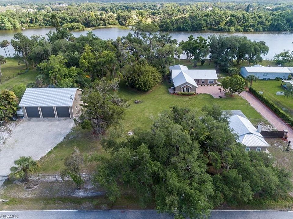 Over view: Cottage home bottom right, Paver driveway leads to main home, on left detached garage.