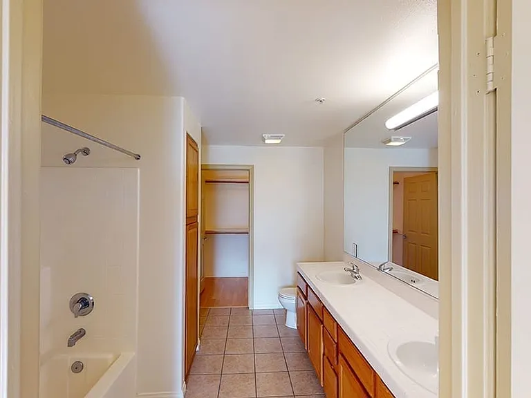 Apartment bathroom with tile flooring.