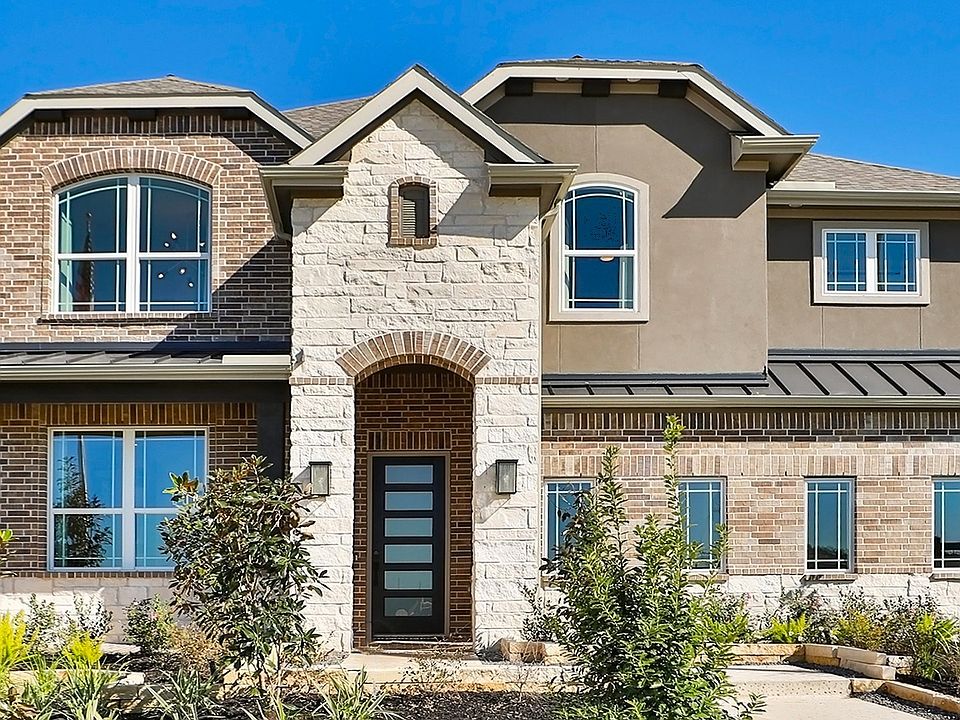 Exquisite brickwork and arched windows define this modern Brookewater residence.