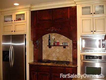 Beautiful Custom Kitchen
						:
						Stainless steel appliances, custom shelving, and tiled floors