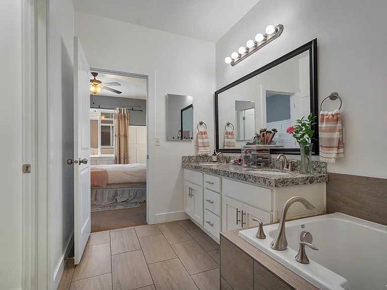 Primary bathroom leading into the bedroom.