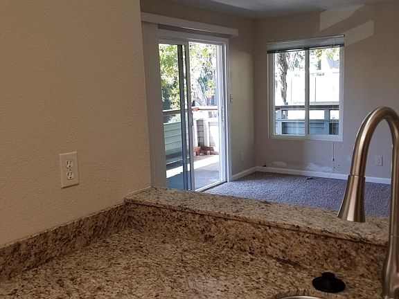 From kitchen pass-through to living room and balcony door.