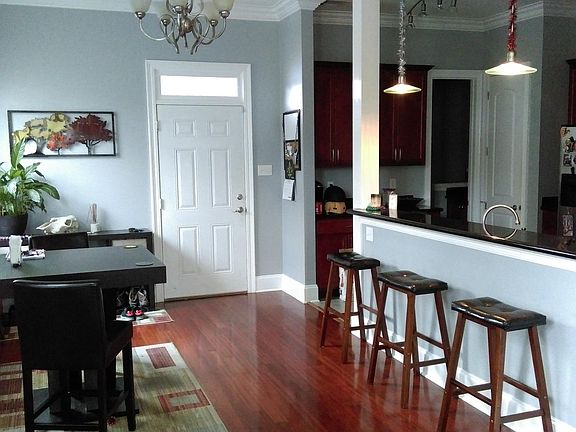 View of dining room and informal dining into kitchen. View of back door.