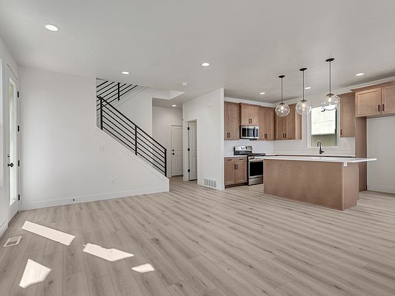 Discover the open-concept modern kitchen and living area, reminiscent of Cascade Village charm, feat