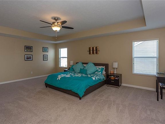 ENORMOUS master bedroom!  That's a king size bed that is dwarfed in that huge space!