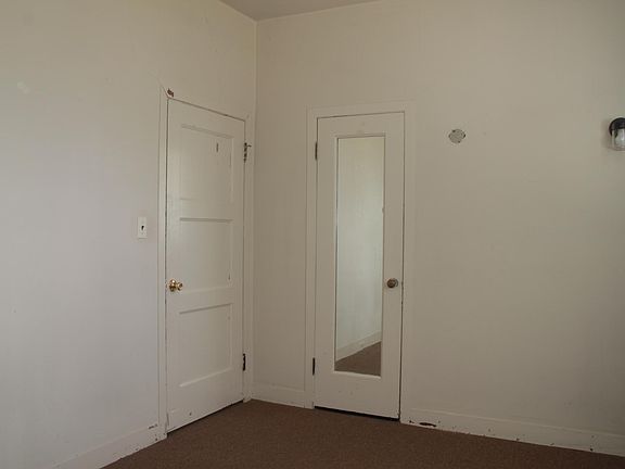 Bedroom 1 - closet has mirror on outside of door. Door on the left leads to the hallway.