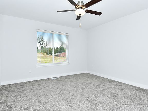 The master suite is spacious and has a large window.