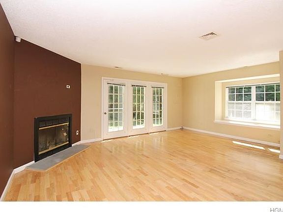 Lovely window seat allows for additional sunlight and interest to the over sized living room