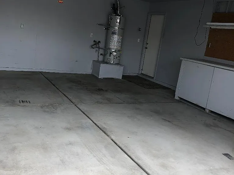 2-Car oversized garage with work cabinet space.