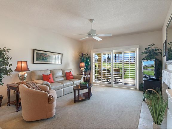 Gorgeous views from the sliding glass doors onto the patio and golf course, with the mountains in the background. Furniture recently replaces for a more comfortable space.