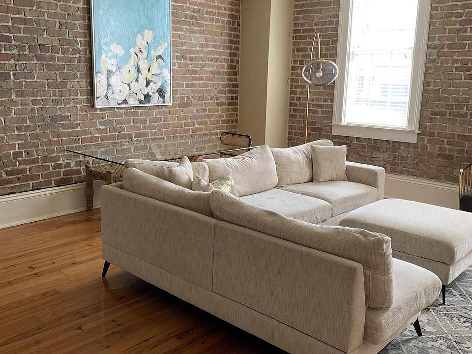 Exposed brick walls frame this renovated furniture manufacturing warehouse with modern features