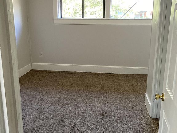 Bedroom 2 with its own closet, ceiling fan, and carpeting.