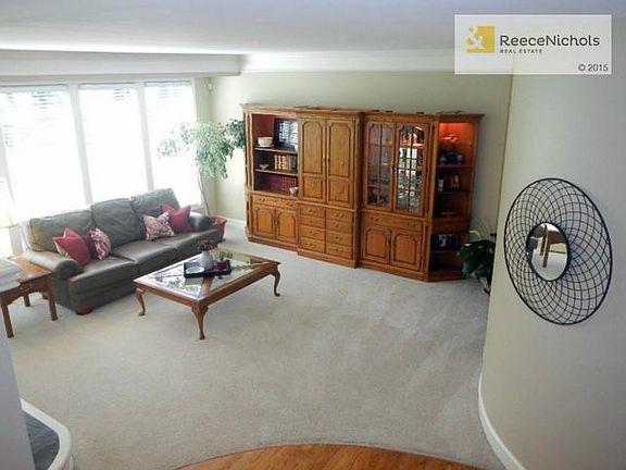Wall of windows brightens this family room with fireplace and me