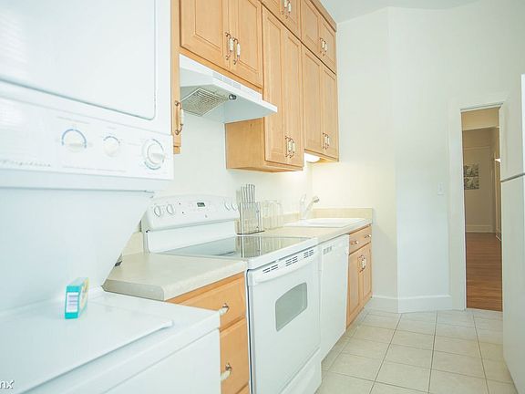 The stacking washer/dryer can be found in the kitchen.