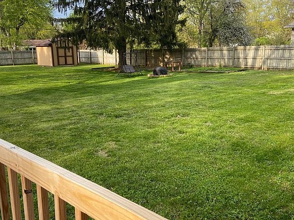 Huge fenced backyard with privacy, mature trees, and a nice shed for tools and storage.