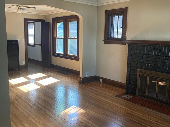 Living room looking to dining room with swing door to kitchen