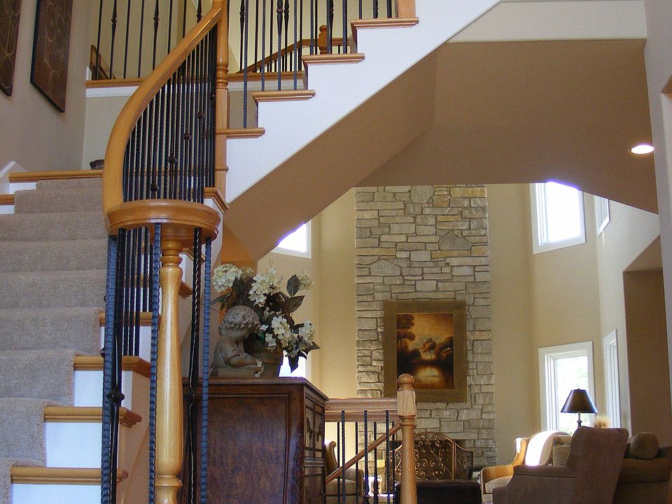 Two Story Foyer w/ wrought iron staircase