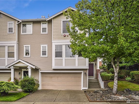 Unit C Townhome offers a end unit Home with lush greenery, a side yard and lovely PNW trees framing the entrance. 