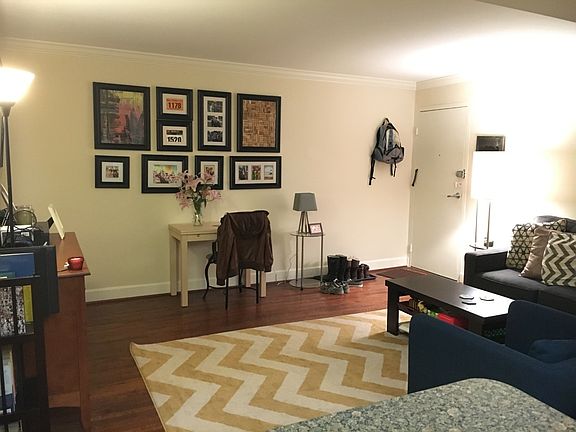 Breakfast bar opens to large living room with original wood
