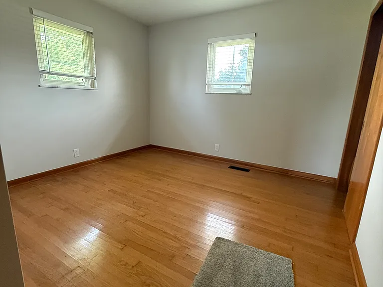 Back bedroom. Two windows overlooking back and side yard.