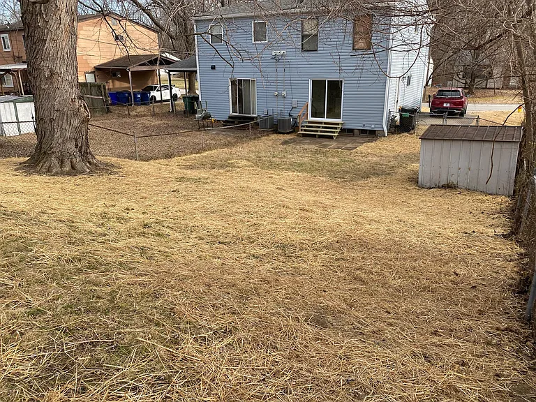 Fenced yard with patio and storage shed