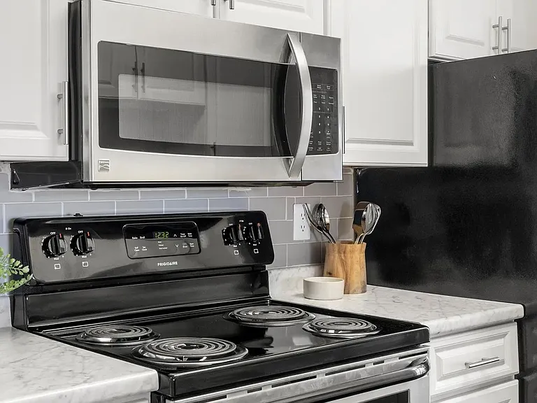 Luxurious stainless-steel appliances paired with stunning subway tile backsplash in every remodeled kitchen.