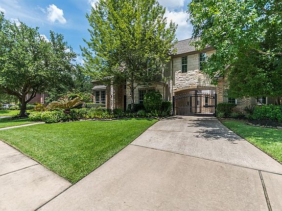 Front elevation also features gated porte-cochere.