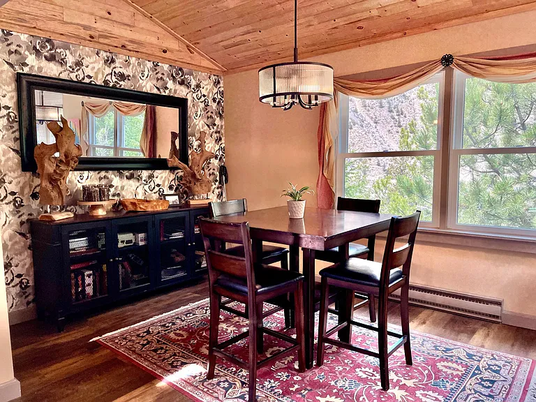 Dining room table recently replaced with a longer, lower 6-seat table for a larger setting.