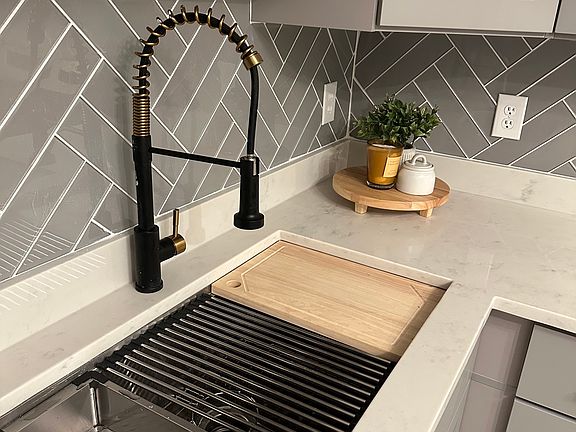 Motion sensor sink, natural stone counter tops.