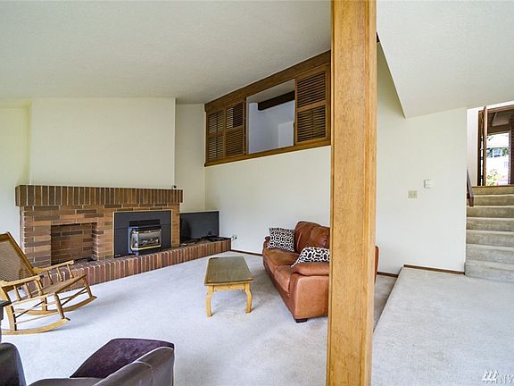 Living area is on the lower level, fireplace is propane, ceilings are vaulted.