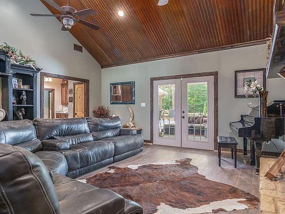 Every inch of the Living Room was thought through during construction. From the wood-look tile floors to the cathedral ceiling, ceiling fans and lighting, to French doors leading to the Outdoor Lounge, this is luxury at its finest.