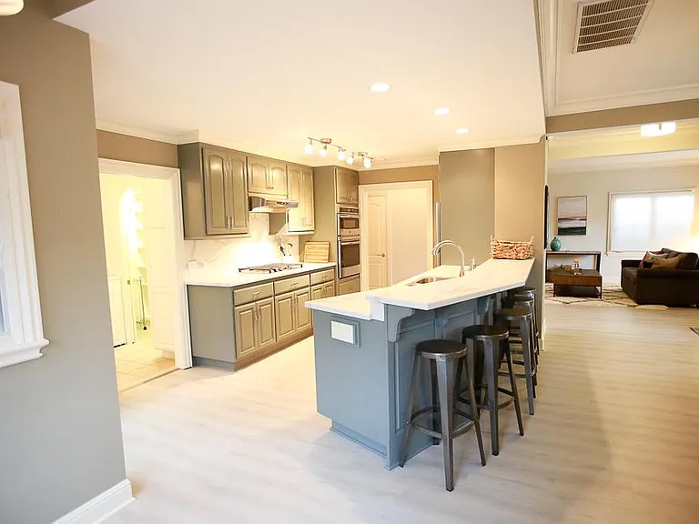 Expansive, open floorplan flowing from one space to the next, with warm and cheerful lighting.