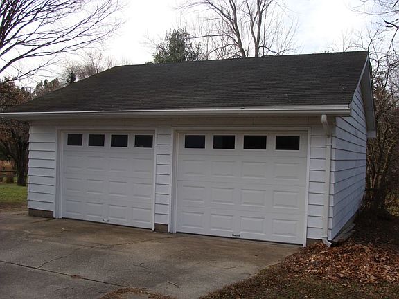 The extra large garage has new windows,new service door and new overhead doors.The  walls are insulated and drywalled and painted.The garage has a work bench also