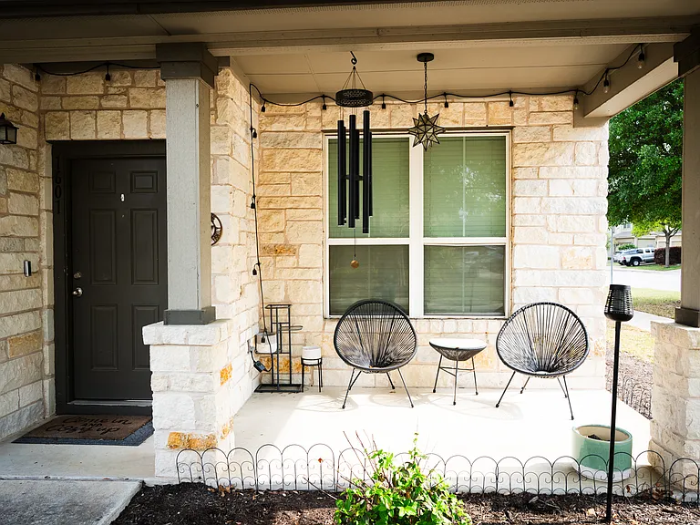 Welcoming front deck with cozy ambient lighting, facing the serene pool
