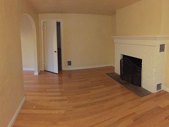 LIVING ROOM Brick Fireplace Door to upstairs bedroom