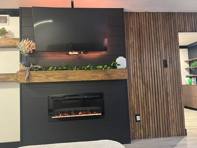 Front view of fireplace and glimpse into the kitchen (on the right).