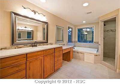 Master bath with double vanities and jacuzzi tub
