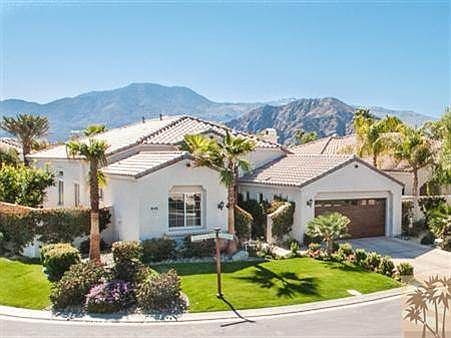 South facing corner lot with huge palms and fruit trees galore!