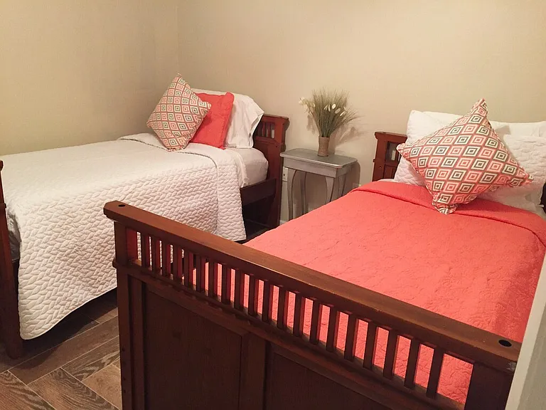 Guest bedroom #1 with walk in closet and tile floors