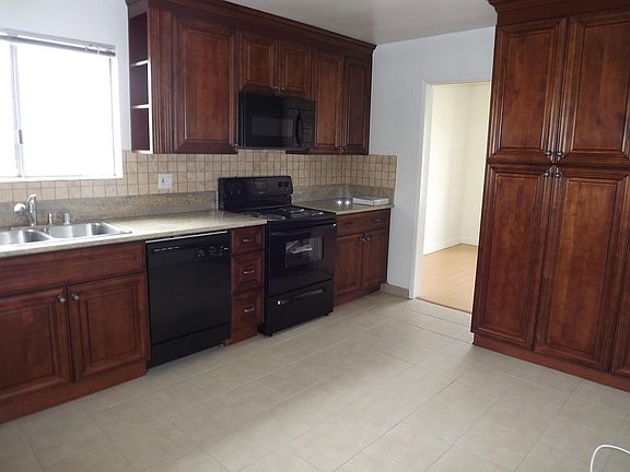 Kitchen with tiled flooring.