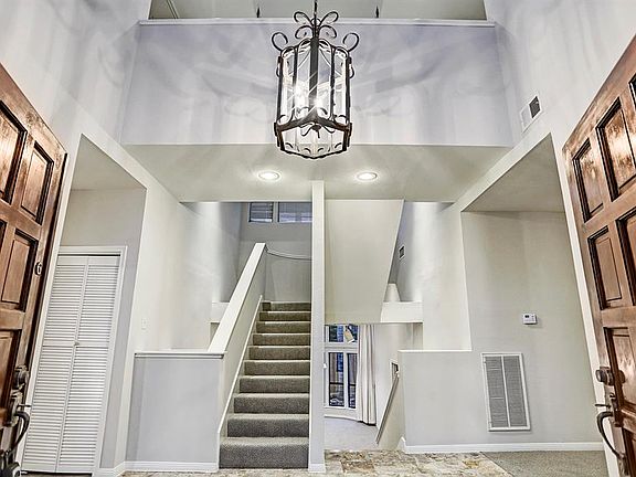 Architecturally appealing in every direction! Soaring ceilings, recessed lighting, marble entry, freshly painted soft gray tones, art niche, oil rubbed bronze chandelier & more!