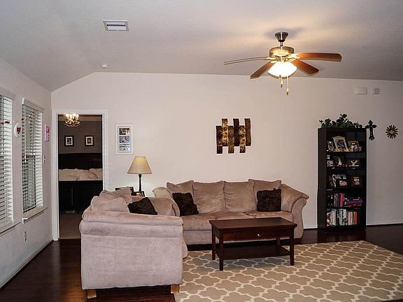 ...Dark hardwood Mowhawk flooring and high ceiling.