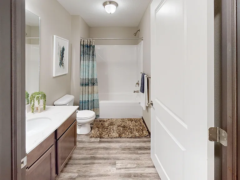 Bathrooms include bright lighting and large vanities.