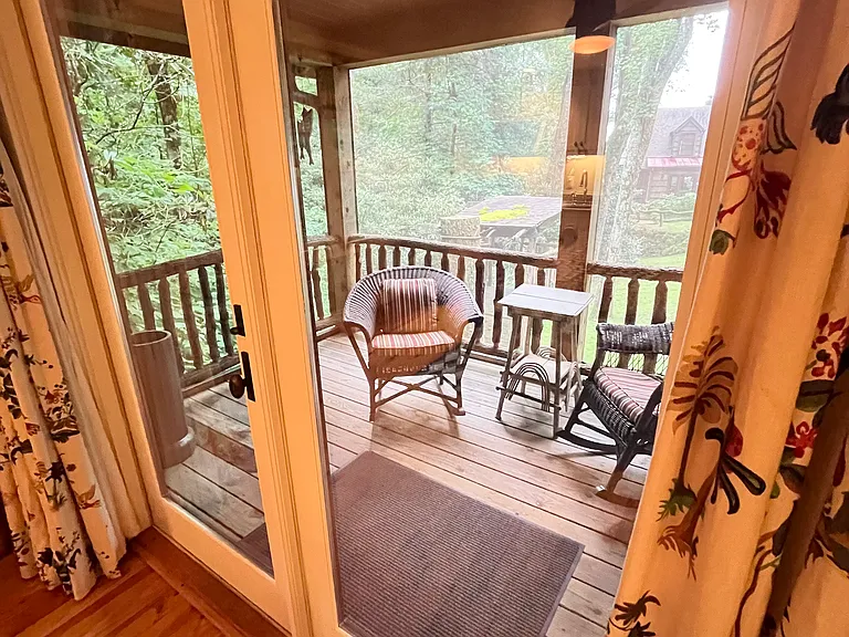 The view from the apartment out the double French doors onto the screen porch.