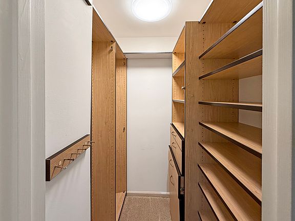 Closet system in the primary bedroom closet