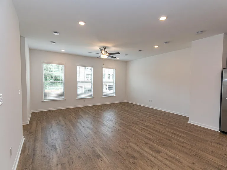 Bright room with wood floors and a large windows, perfect for a kitchen table.