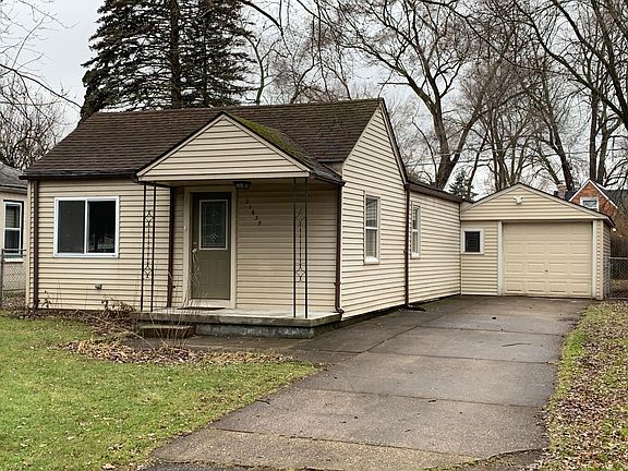 One car garage with extra parking in driveway and security lighting